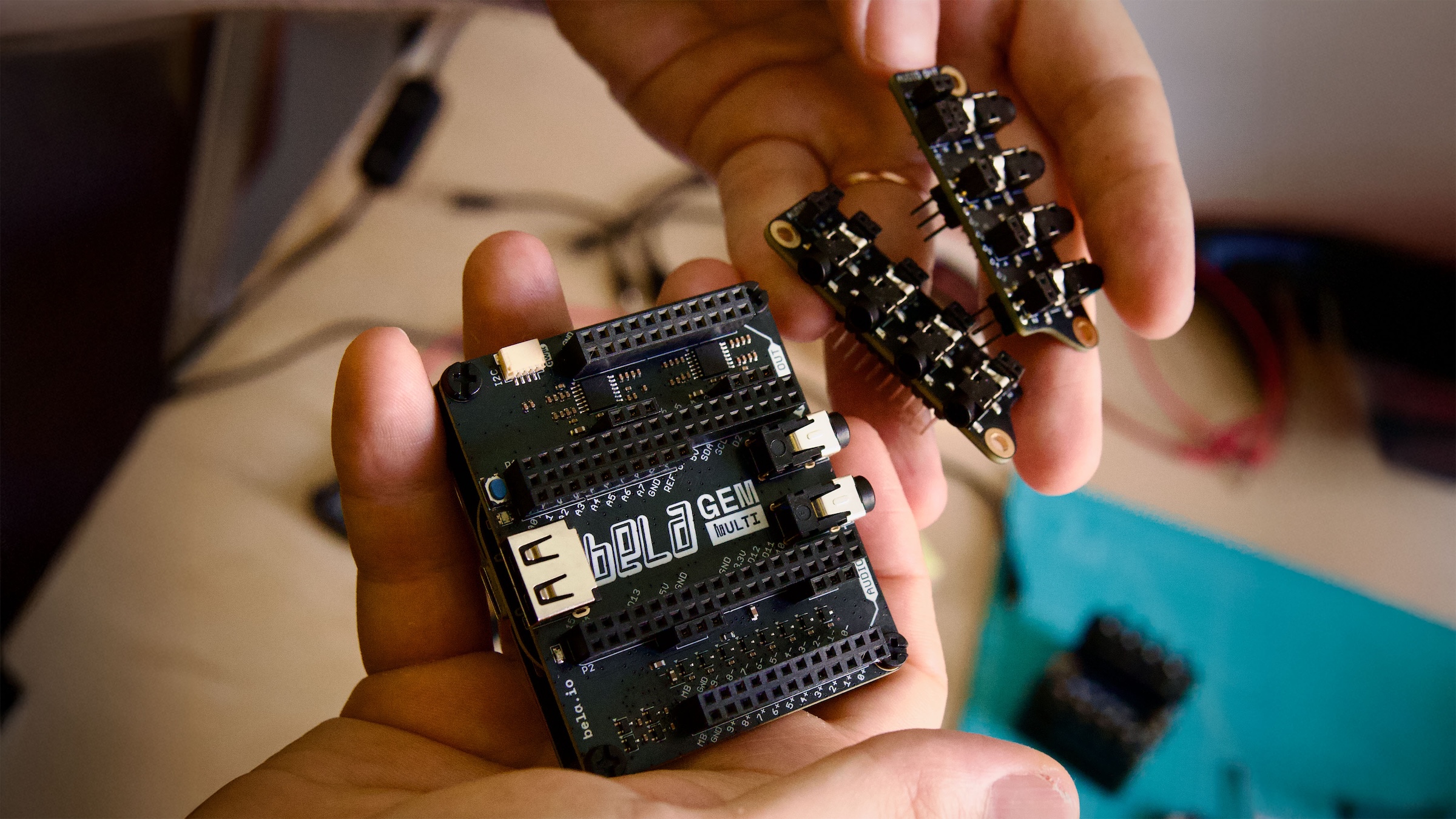 A Bela Gem system at an angle, surrounded by various electronic parts and components